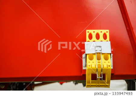 Yellow brake stop blocks wedges on red tractorの写真素材 [133947493] - PIXTA