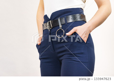 Woman wearing high waist trouser with belt 133947623