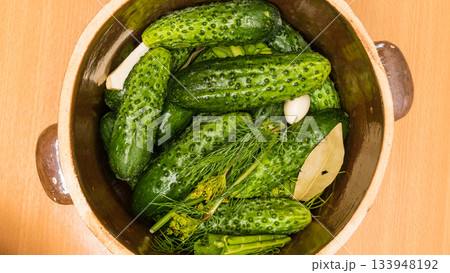 Making pickled cucumbers in clay jar 133948192