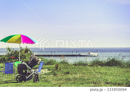 Picnic on beach. Umbrella with chairs 133950094