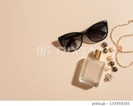 Sunglasses and perfume on beige background Sunglasses and perfume on beige background 133950385