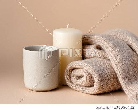 Cozy candle with ceramic cup and blanket 133950412
