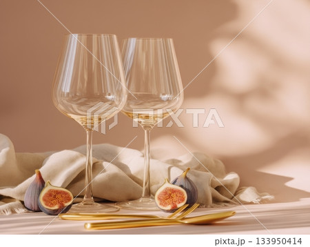 Romantic wine glasses with figs and gold cutlery Romantic wine glasses with figs and gold cutlery 133950414