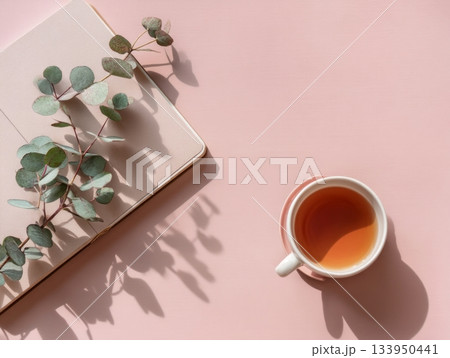 Coffee cup with notebook and eucalyptus leaves 133950441