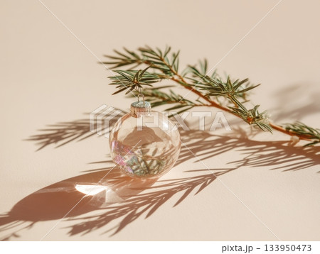 Glass bauble and pine twig on silk 133950473
