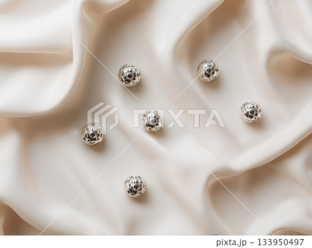 Silver Christmas ornaments on silk fabric 133950497