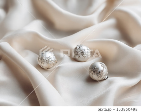 Silver Christmas ornaments on silk fabric 133950498