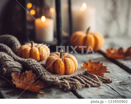 Cozy autumn still life with pumpkins and candle Cozy autumn still life with pumpkins and candle 133950902