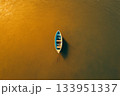 Boat with Person on Glittering Water 133951337