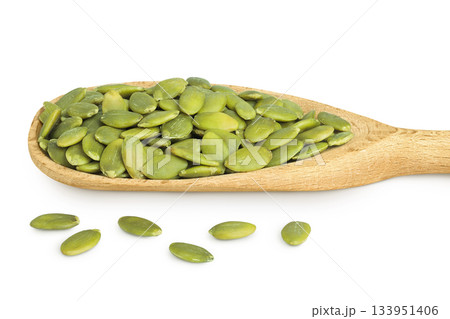 Peeled pumpkin seeds in wooden spoon isolated on white background 133951406