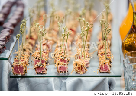Delicious tuna appetizers being served at a wedding reception Delicious tuna appetizers being served at a wedding reception 133952195