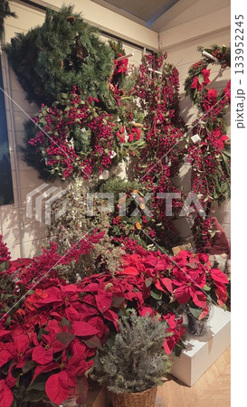 Festive Christmas decorations with poinsettias and wreaths for holiday celebration 133952245