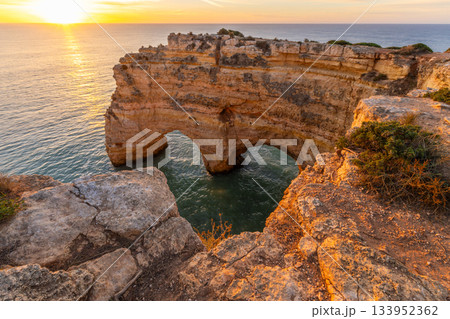 Heart of the Algarve Arch near Marinha Beach. Atlantic Ocean at Sunrise. Algarve, Portugal Heart of the Algarve Arch near Marinha Beach. Atlantic Ocean at Sunrise. Algarve, Portugal 133952362