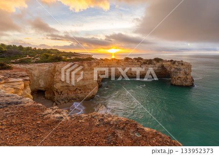Rock Formations near Albandeira Beach, Atlantic Ocean at Sunrise. Algarve, Portugal Rock Formations near Albandeira Beach, Atlantic Ocean at Sunrise. Algarve, Portugal 133952373