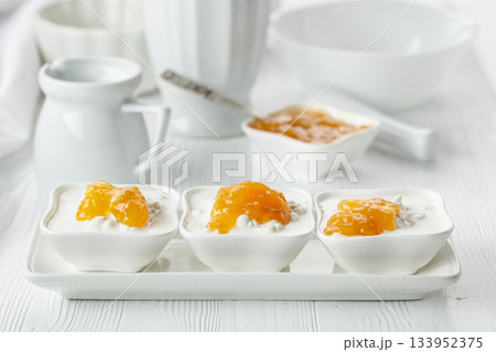 Cottage cheese with cream and apricot jam. Cottage cheese with cream and apricot jam. 133952375