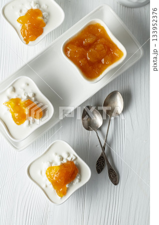 Cottage cheese with cream and mango jam. Cottage cheese with cream and mango jam. 133952376