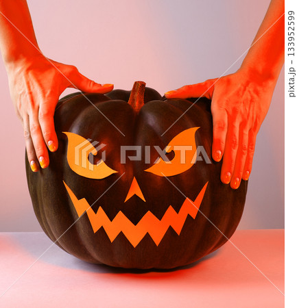 Halloween Pumpkin with Paper Cut Scary Face on a White Background. Jack Halloween. Smile Jack Pumpkin Halloween Pumpkin with Paper Cut Scary Face on a White Background. Jack Halloween. Smile Jack Pumpkin 133952599
