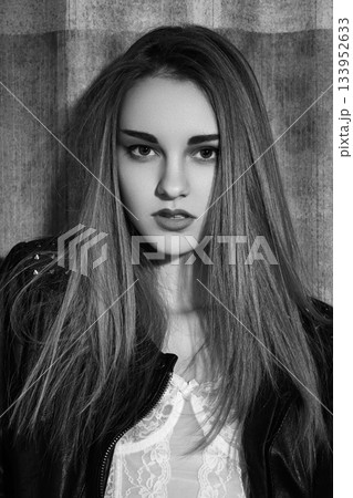 Beautiful fashion woman model in rock leather jacket, dark make-up. Street fashion look. Long hairstyle, straight hair Beautiful fashion woman model in rock leather jacket, dark make-up. Street fashion look. Long hairstyle, straight hair 133952633