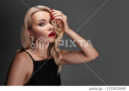 Beautiful Woman with Fashion Make-up and Blond Wave Hairstyle. Glamour American Diva Style with Brilliant Accessories 133952640