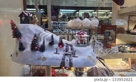 Festive Christmas village display with snow and lights for holiday decor inspiration Festive Christmas village display with snow and lights for holiday decor inspiration 133952821
