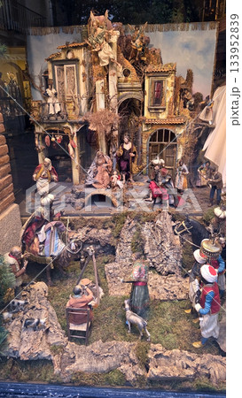 Traditional Christmas nativity scene display with figurines and rustic architecture. A nativity scene in a shop window. Christmas belen 133952839