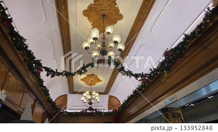 Elegant christmas garland and chandelier display in festive interior setting 133952848