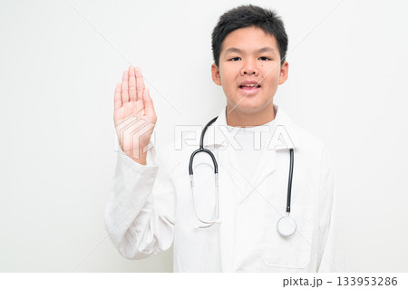 Young Asian Boy Dressed as Doctor with Stethoscope Waving Hand Young Asian Boy Dressed as Doctor with Stethoscope Waving Hand 133953286