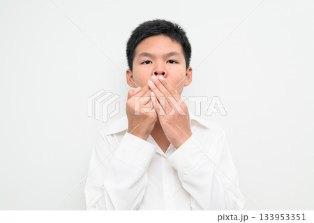 Asian Teenage Boy Student Studio Portrait on White Background Covering Mouth Asian Teenage Boy Student Studio Portrait on White Background Covering Mouth 133953351