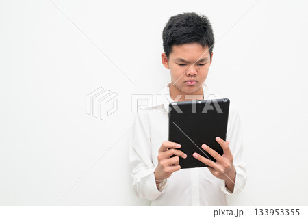 Asian Teenage Boy Student Studio Portrait on White Background Using Digital Tablet Computer 133953355
