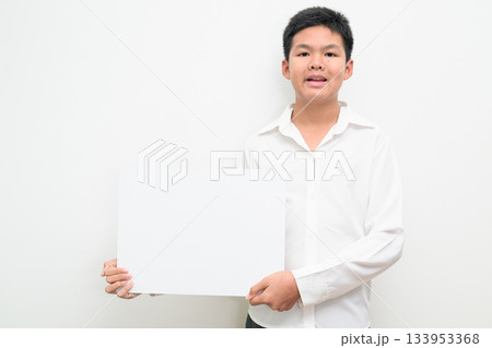 Asian Teenage Boy Student Studio Portrait on White Background Showing Empty Placard with Copy Space Asian Teenage Boy Student Studio Portrait on White Background Showing Empty Placard with Copy Space 133953368