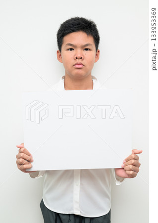 Asian Teenage Boy Student Studio Portrait on White Background Showing Empty Placard with Copy Space Asian Teenage Boy Student Studio Portrait on White Background Showing Empty Placard with Copy Space 133953369