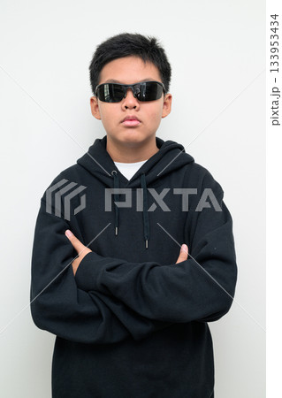 Asian Teenage Boy in Hoodie Wearing Sunglasses Asian Teenage Boy in Hoodie Wearing Sunglasses 133953434