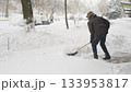 Worker Clears Deep Snow From Outdoor Walkway In Winter 133953817
