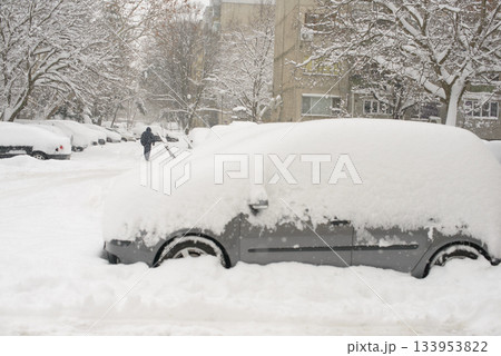 Vehicles Buried In Heavy Snow As Person Walks Along Winter Street Vehicles Buried In Heavy Snow As Person Walks Along Winter Street 133953822