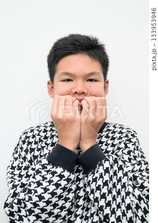 Asian Teenage Boy Studio Portrait on White Background Looking Scared and Afraid Biting Nails Asian Teenage Boy Studio Portrait on White Background Looking Scared and Afraid Biting Nails 133953946