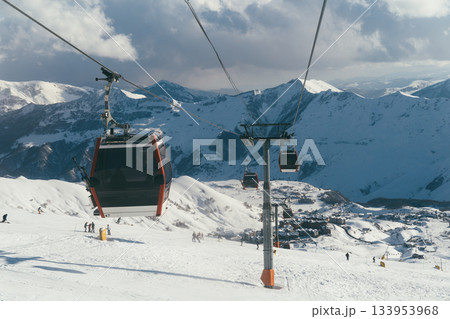 Ski lift in Gudauri, Georgia, transporting skiers through snowy mountains Ski lift in Gudauri, Georgia, transporting skiers through snowy mountains 133953968