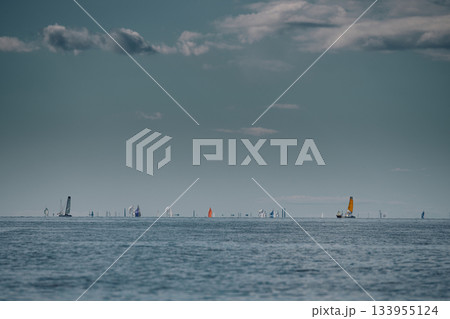Sailing regatta in the Gulf of Finland at sunny day, a lot of sailing yachts competing in a race, teamwork, board the boat Sailing regatta in the Gulf of Finland at sunny day, a lot of sailing yachts competing in a race, teamwork, board the boat 133955124