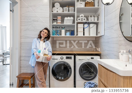 Woman housewife posing at modern white wooden bathroom laundry storage minimalism organizing 133955736