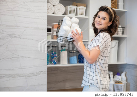 Woman housewife white bathroom general cleaning cupboard shelves storage organizing eco minimalism 133955743