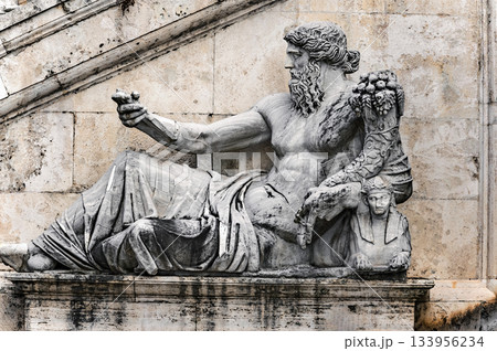 Ancient Statue in front of stairs into Palazzo Senatorio in Rome, Italy. 133956234