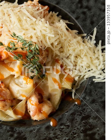 Cheesy shrimp and pasta dish served hot, Smooth shrimp and pasta with Parmesan and thyme sauce Cheesy shrimp and pasta dish served hot, Smooth shrimp and pasta with Parmesan and thyme sauce 133957358
