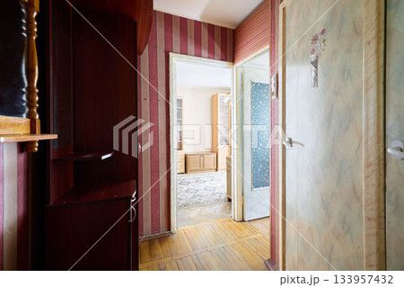 Old hallway scenes, Wornout vintage apartment hallway with sunlight streaming and faded floral decor 133957432