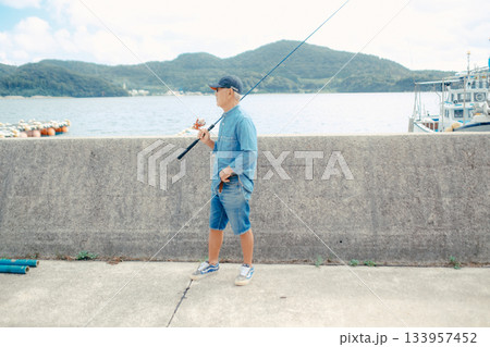 釣り竿を眺めるシニア男性 釣り竿を眺めるシニア男性 133957452