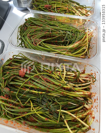 Pa kimchi, a flavorful Korean side dish made with scallions, fermented in a spicy, tangy seasoning. Perfect for enhancing meals, this vibrant dish captures the essence of traditional Korean cuisine. 133958315