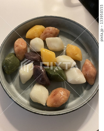 Songpyeon, a traditional Korean rice cake, filled with sweet fillings like sesame seeds, red bean paste, or chestnuts. Fragrant aroma and chewy texture, often enjoyed during the Chuseok festival. 133958555