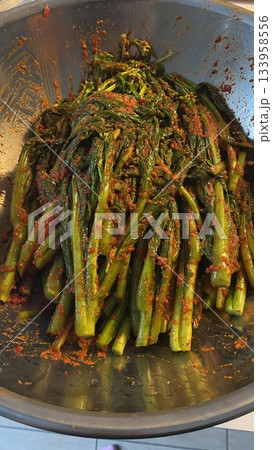 Pa kimchi, a flavorful Korean side dish made with scallions, fermented in a spicy, tangy seasoning. Perfect for enhancing meals, this vibrant dish captures the essence of traditional Korean cuisine. 133958556