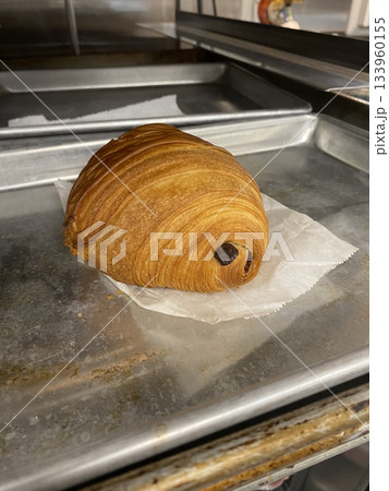 A croissant is a classic French pastry known for its buttery, flaky layers and golden crust. Often enjoyed plain or filled with chocolate, almond, or ham and cheese, it’s a perfect for breakfast 133960155