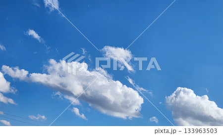 Bright Blue Sky With Large White Cloud Formation Over Open Horizon 133963503
