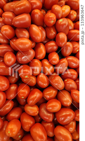 Fresh Red Cherry Tomatoes Piled High, Small Grape Tomatoes for Market and Cooking Fresh Red Cherry Tomatoes Piled High, Small Grape Tomatoes for Market and Cooking 133963647