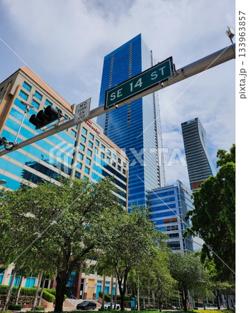 Modern City Street with Skyscrapers and Sign 133963857